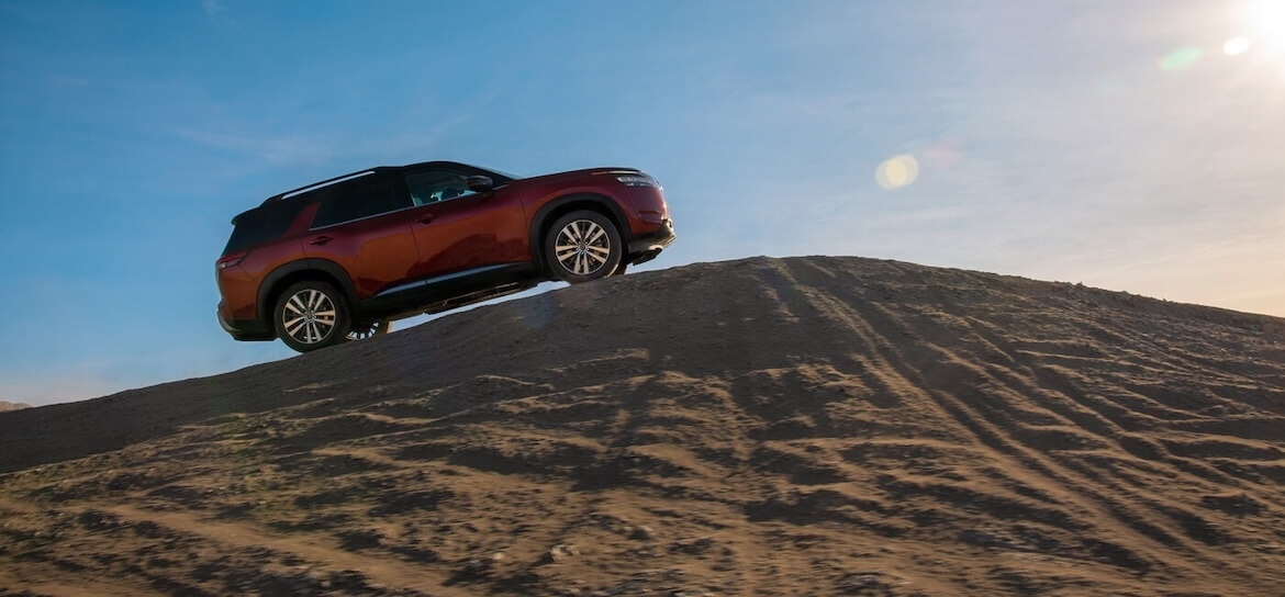 Nissan Pathfinder 2025 montant une montagne de sable.